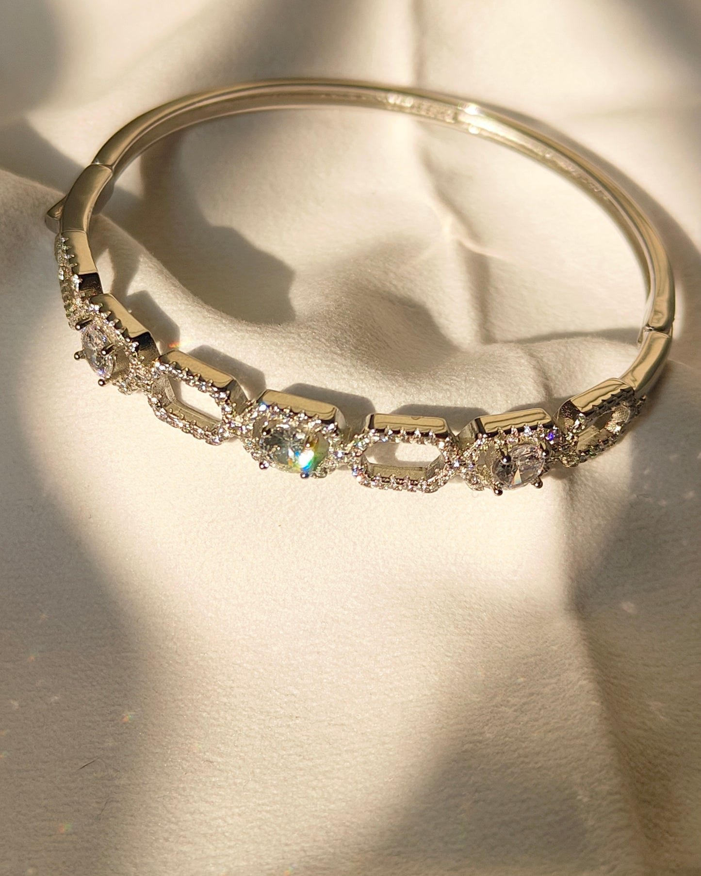 Gold bracelet with diamonds on a light background