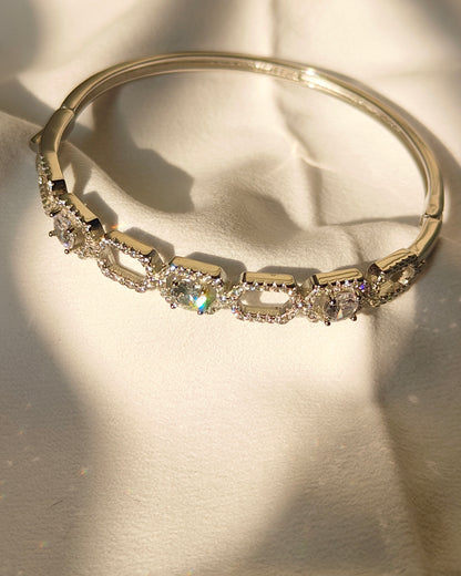 Gold bracelet with diamonds on a light background