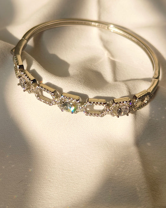 Gold bracelet with diamonds on a light background